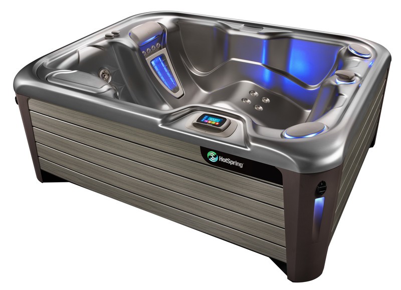 A high-quality Hot Spring spa featuring a durable acrylic shell in a neutral tone, complemented by a stylish wood-paneled exterior.