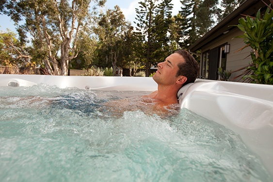 an image of a man relaxing in a hot tub to promote a better night's sleep